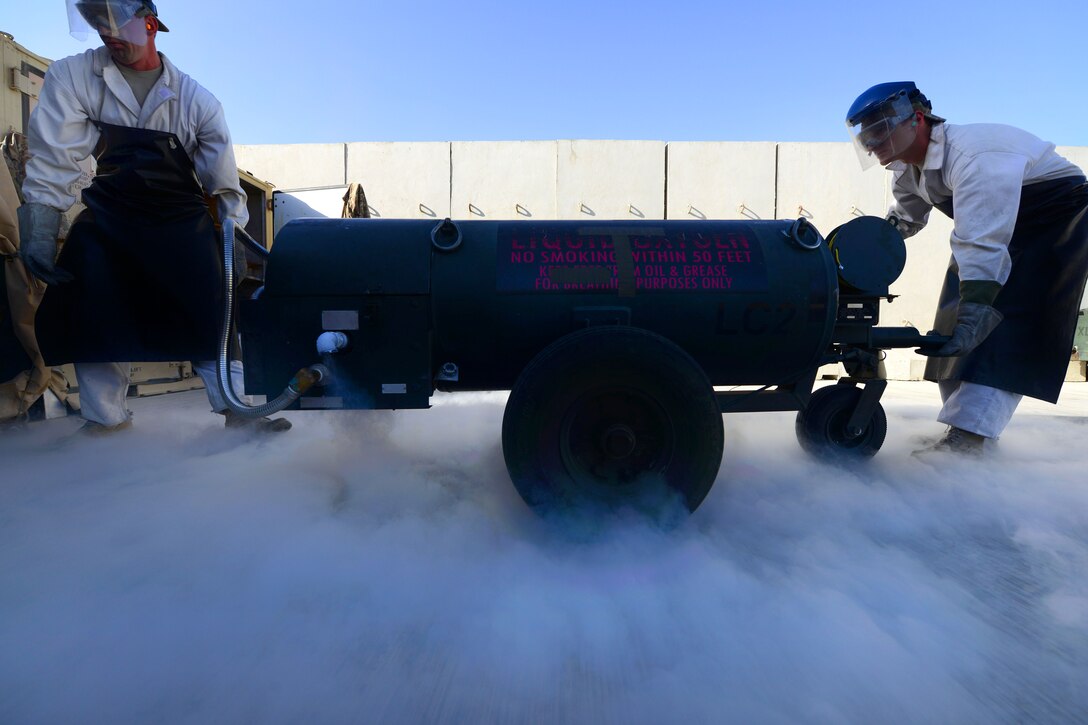 U.S. Air Force Staff Sgts. James Brumbaugh, left, and Taj Copeland move a liquid oxygen cart during a cryogenic refill on Bagram Airfield, Afghanistan, Sept. 5, 2014. 
Brumbaugh is a fuels cryogenics noncommissioned officer in charge and Copeland is a fuels distribution supervisor assigned to the 455th Expeditionary Logistics Readiness Squadron.