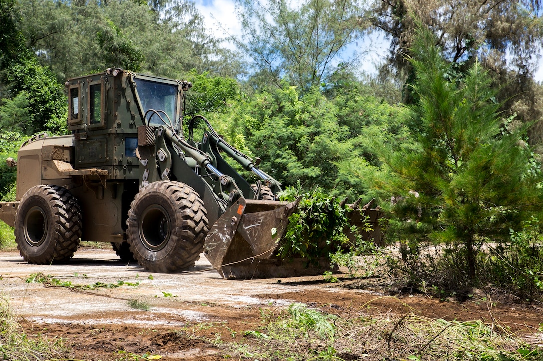 A heavy equipment operator operates a 624 KR tractor, rubber tire, articulated, multipurpose, also known as a bucket loader, at West Field, Tinian, Aug. 31 during Exercise Valiant Shield 2014. Valiant Shield is a biennial exercise which focuses on training that enables real-world proficiency in sustaining joint forces. The mission of the HE operators during Valiant Shield is to clear an old runway, 500 by 7,000 feet, of thick jungle. The heavy equipment operator is with Marine Wing Support Squadron 171, Marine Aircraft Group 12, 1st Marine Aircraft Wing, III Marine Expeditionary Force. (U.S. Marine Corps photo by Cpl. D. A. Walters/Released)