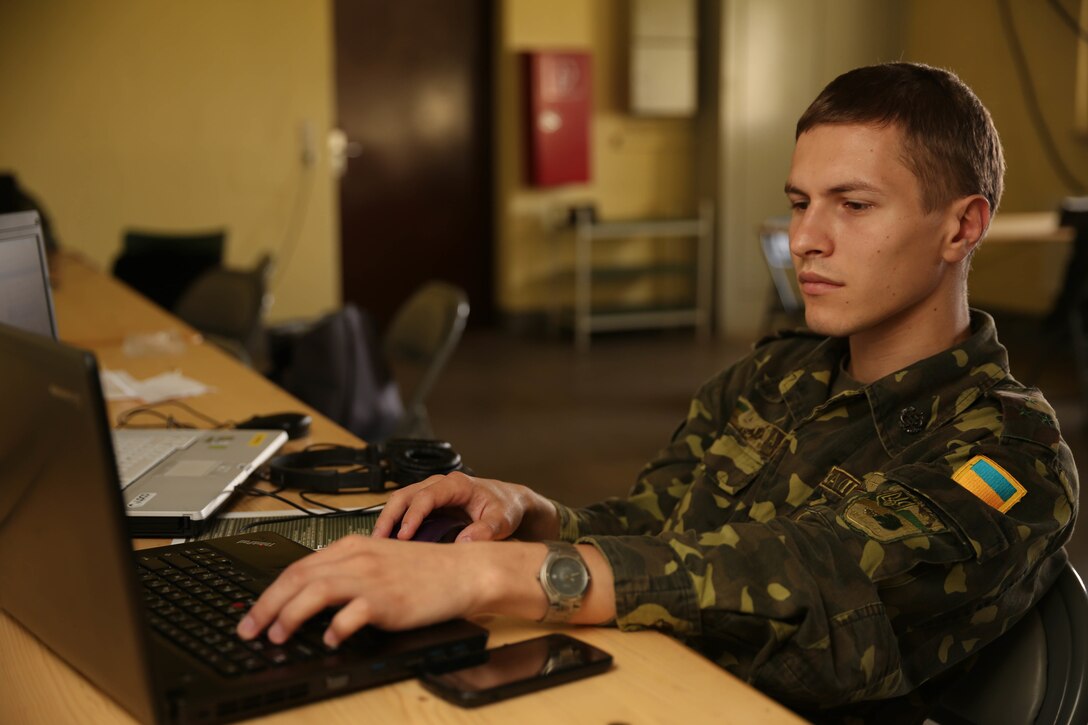 Ukraine Army First Lieutenant Vitalii Dudnyk monitors the Ukrainian mission group’s cyber-network to detect and alleviate virtual attacks during exercise Combined Endeavor 14 in Grafenwhor, Germany, Sept. 9. Combined Endeavor is the world's largest command, control, communication and computer (C4) systems exercise. More than 1,200 communications professionals from 31 NATO and Partnership of Peace countries along with European security partners are participating.