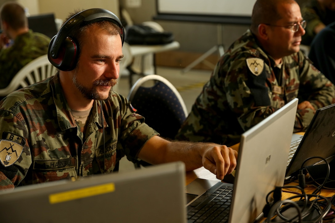 Slovenian Armed Forces Cpl. Andres Hares, fault and performance monitor with the combined staff 6, responsible for information assurance, network monitoring and system analysis, assesses a mission group’s response to a cyber-attack during exercise Combined Endeavor 14 in Grafenwhor, Germany, Sept. 9. Combined Endeavor is the world's largest command, control, communication and computer (C4) systems exercise. More than 1,200 communications professionals from 31 NATO and Partnership of Peace countries along with European security partners are participating.