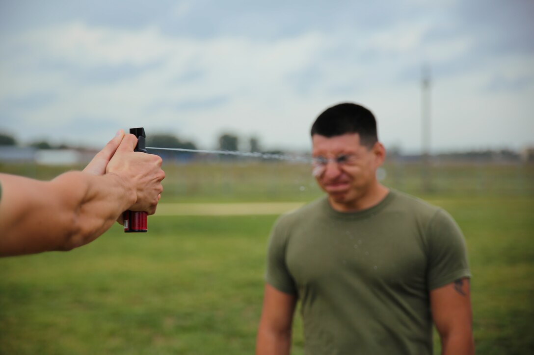 A Marine from Golf Co., 2nd Battalion, 2nd Marines receives a painful blast of Oleoresin Capsicum spray during Black Sea Rotational Force 14 Sept. 3 at a non-lethal weapons course on Mihail Kogalniceanu Air Base, Romania. Experience gained during the non-lethal weapons course helps Marines share knowledge with partner nations in the Black Sea region.  (U.S. Marine Corps photo by Lance Cpl. Ryan Young/released)