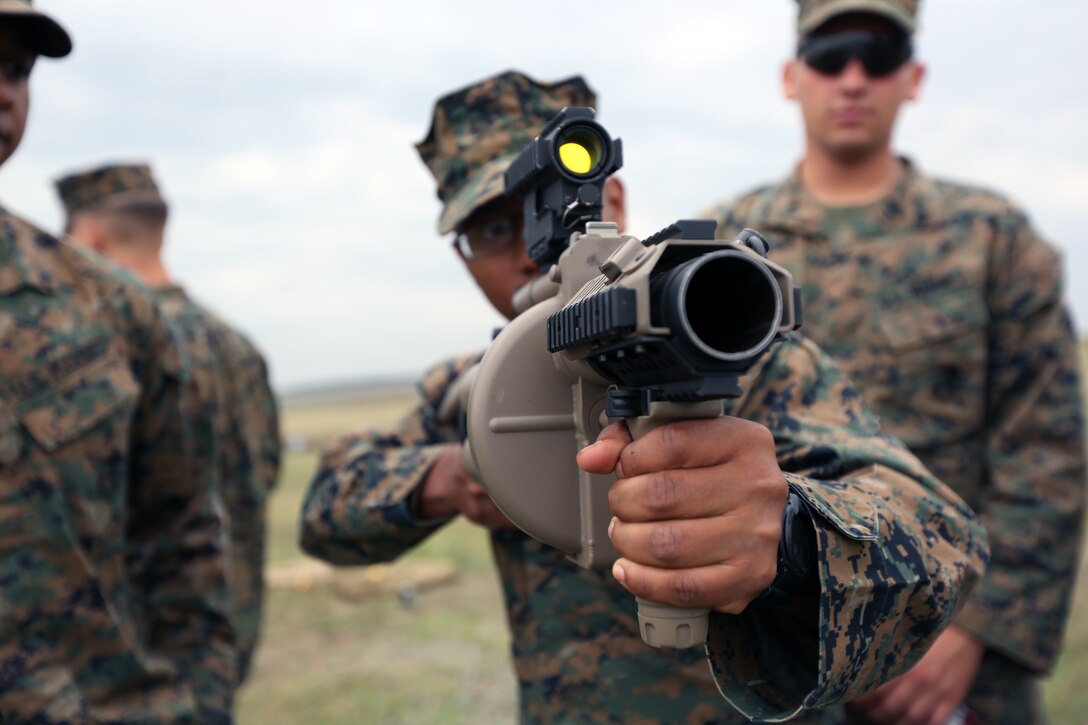 A Marine with Black Sea Rotational Force 14 from sights in on a target using the M32 Multiple Grenade Launcher Sept. 8, during a non-lethal weapons range near Mihail Kogalniceanu Air Base, Romania. The current iteration of BSRF-14 will conduct non-lethal weapons training with Eastern European security partners during their six-month rotation. (U.S. Marine Corps photo by Lance Cpl. Ryan Young/released)