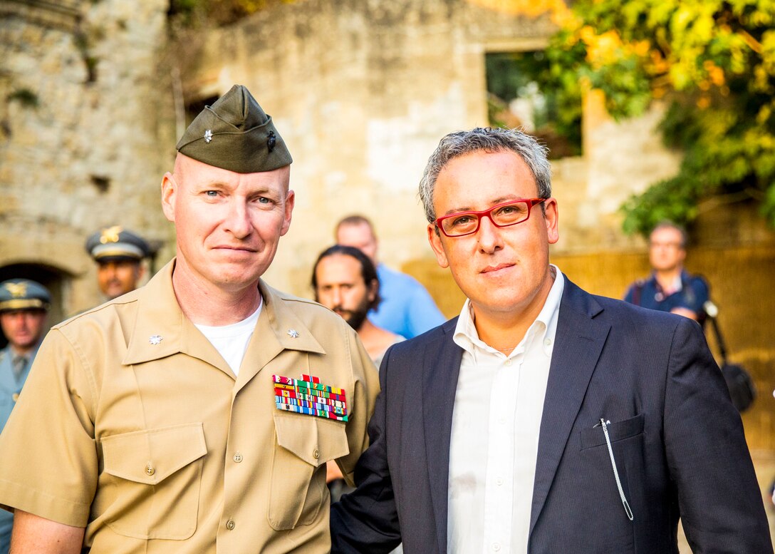 Lt. Col. William C. Stophel, the commanding officer of Special-Purpose Marine Air-Ground Task Force Africa 14 poses for a photo with Marco Sinatra, the mayor of Vizzini, in Cunziria, Vizzini, Sept. 7, 2014. At the award ceremony, Mayor Sinatra said “In the world of conflict that we see today, culture is the cradle of civilization…It’s a way to have everybody joining together and [bond] together. This has been a common element, which has brought both Americans and Italians together towards peace, and preserving the historic heritage, which is what we are doing today.”