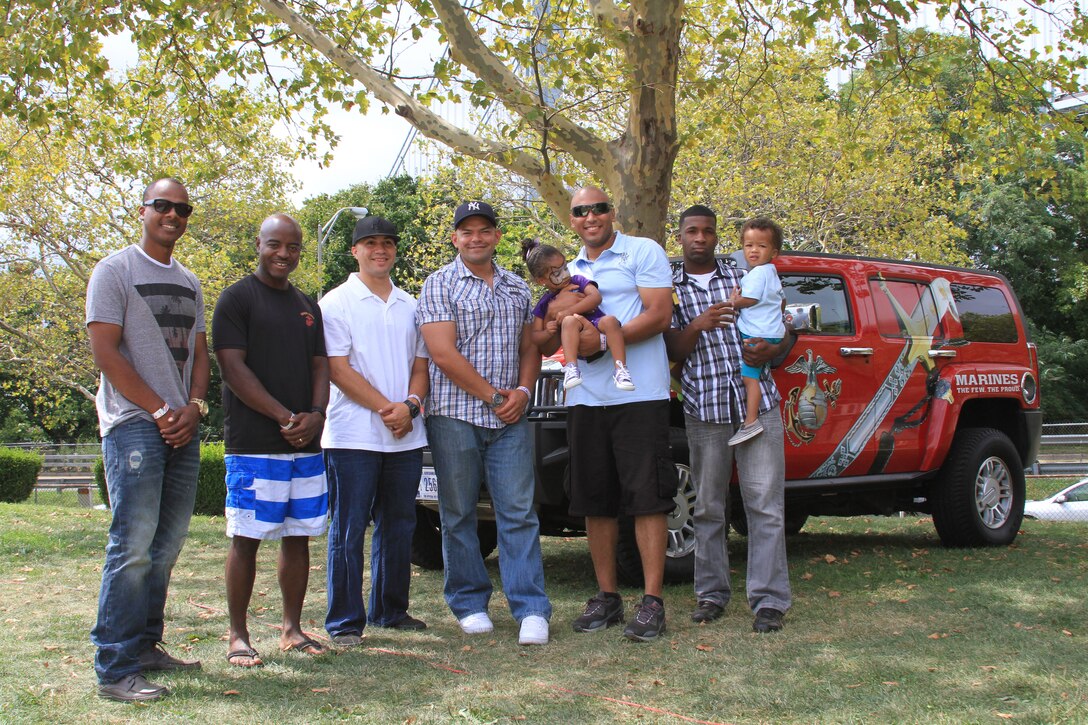 Marine Corps Recruiting Substation Flatbush Marines pose for a photo with a couple of their family members during Recruiting Station New York's annual Family Day Aug. 30. This year's family day was held on Army Garrison Fort Hamilton in Brooklyn, N.Y. 