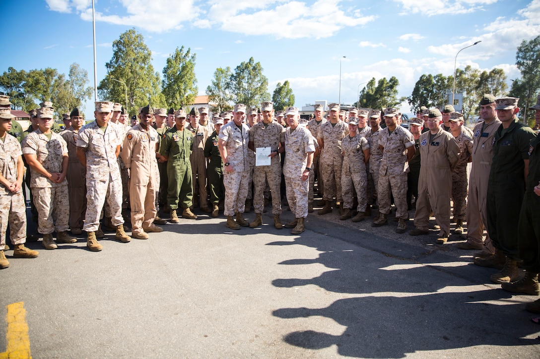 Lance Corporal Antonio C. Galloway (center), an aircraft communications, navigation, electrical and weapon systems technician with Marine Medium Tiltrotor Squadron [VMM 264], poses for a photo with General James F. Amos (right center), 35th Commandant of the Marine Corps and Sgt. Maj. Micheal P. Barrett, Sergeant Major of the Marine Corps (center left) and other service members with VMM 264 aboard Naval Air Station Sigonella, Sicily, Sept. 3, 2014. (U.S. Marine Corps photo by Cpl. Shawn Valosin)