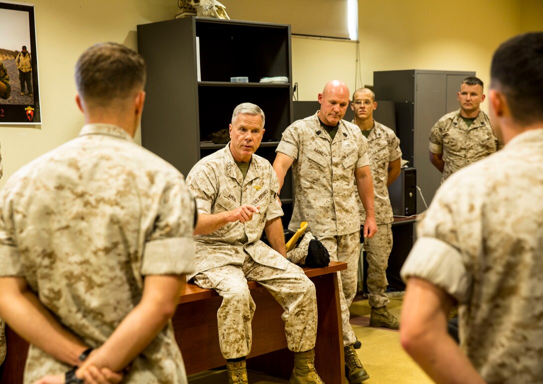 General James F. Amos, 35th Commandant of the Marine Corps (left sitting), speaks to service members with Special-Purpose Marine Air-Ground Task Force 14 during a visit aboard Naval Air Station Sigonella, Sicily, Sept. 3, 2014. During the visit, Amos and Sgt. Maj. Micheal P. Barrett walked through individual work sections at SP-MAGTF Africa to meet [and get to know] the service members. After the walkthrough they meritoriously promoted Lance Cpl. Antonio C. Galloway, an aircraft communications, navigation, electrical and weapon systems technician with Marine Medium Tiltrotor Squadron [VMM 264], to the rank of corporal. (U.S. Marine Corps photo by Cpl. Shawn Valosin)