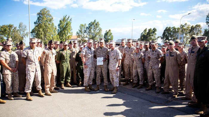 Lance Corporal Antonio C. Galloway (center), an aircraft communications, navigation, electrical and weapon systems technician with Marine Medium Tiltrotor Squadron [VMM 264], poses for a photo with General James F. Amos (right center), 35th Commandant of the Marine Corps and Sgt. Maj. Micheal P. Barrett, Sergeant Major of the Marine Corps (center left) and other service members with VMM 264 aboard Naval Air Station Sigonella, Sicily, Sept. 3, 2014. (U.S. Marine Corps photo by Cpl. Shawn Valosin)