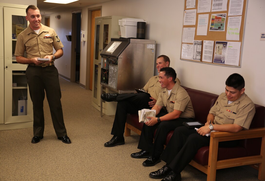 Petty Officer 3rd Class Phillip A. Babcock, (left), corpsman, Ground Combat Element Integrated Task Force, instructs sailors on Fleet Marine Force knowledge at the unit’s task force aid station, Sept. 12, 2014. GCEITF sailors are studying for their evaluation to earn FMF qualification. From October 2014 to July 2015, the Ground Combat Element Integrated Task Force will conduct individual and collective skills training in designated combat arms occupational specialties in order to facilitate the standards based assessment of the physical performance of Marines in a simulated operating environment performing specific ground combat arms tasks. (U.S. Marine Corps photo by Cpl. Paul S. Martinez/Released)