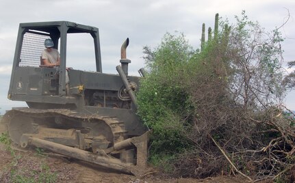 Senior Airman Michael Strobel, a civil engineers with the 190th Air Refueling Wing of the Kansas Air National Guard, clears land for the placement of tents in anticipation of Haitian refugees at Guantanamo Bay, Cuba.