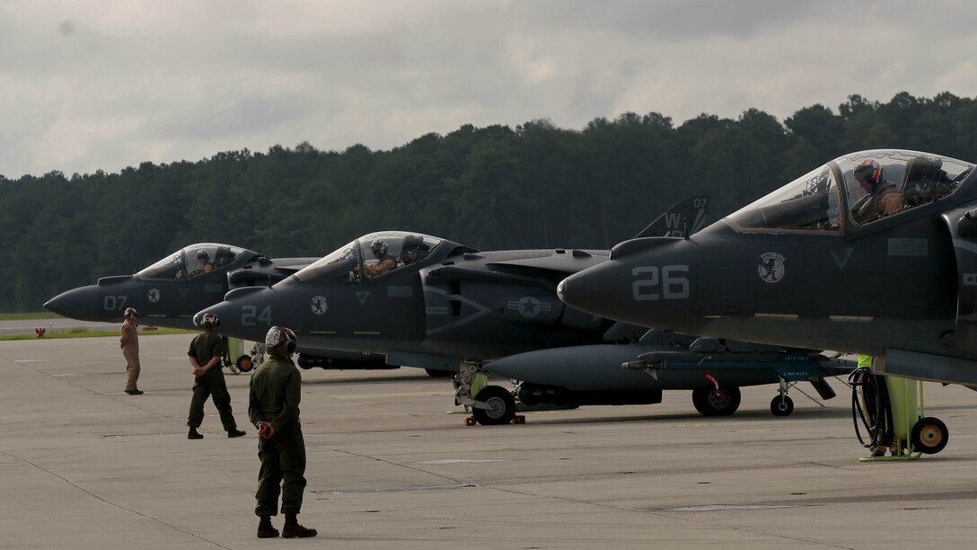 Marines prepare to guide a AV-8B Harriers down the flightline at Marine Corps Air Station Cherry Point, N.C., Sept. 10, 2014. The Harriers were part of a detachment of more than 160 Marines leaving for exercise Green Flag at Nellis Air Force Base, Las Vegas, Nev.