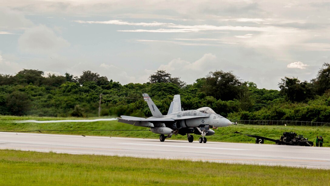 An FA-18C hornet with Marine Fighter Attack Squadron 115, currently assigned to Marine Aircraft Group 12, 1st Marine Aircraft Wing, III Marine Expeditionary Force, makes an arrested landing using the M31 Marine Corps expeditionary arresting gear system during Valiant Shield 2014. Valiant Shield is a U.S.-only exercise integrating U.S. Navy, Air Force, Army and Marine Corps assets, offering real-world joint operational experience to develop capabilities that provide a full range of options to defend U.S. interests and those of its allies and partners. 