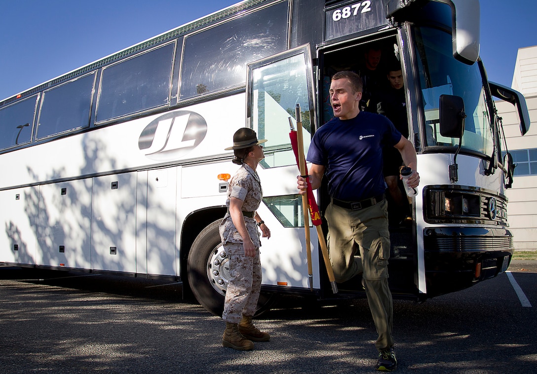 Sgt. Tiffany Nielsen-Nowakowski, a drill instructor with 4th Recruit Training Battalion, Marine Corps Recruit Depot Parris Island, S.C., motivates Philip Samoylovich, a poolee from Recruiting Substation Burlington, to exit a bus during Recruiting Station Seattle’s annual west side pool function at Foster High School in Tukwila, Wash., Sept. 13, 2014. During the event, Washington-based recruiters teamed with drill instructors to physically and mentally prepare enlistees for boot camp. The enlistees, part of the Marine Corps delayed entry program, are awaiting their ship dates. Nielsen-Nowakowski, 26, is from Ferris, Texas. Samoylovich, 20, is from Bellingham, Wash., and attended Ferndale High School in Ferndale, Wash. He was recruited by Sgt. Justin McKelvey and lost 116 lbs. to enlist in the Marine Corps. (U.S. Marine Corps photo by Sgt. Reece Lodder)