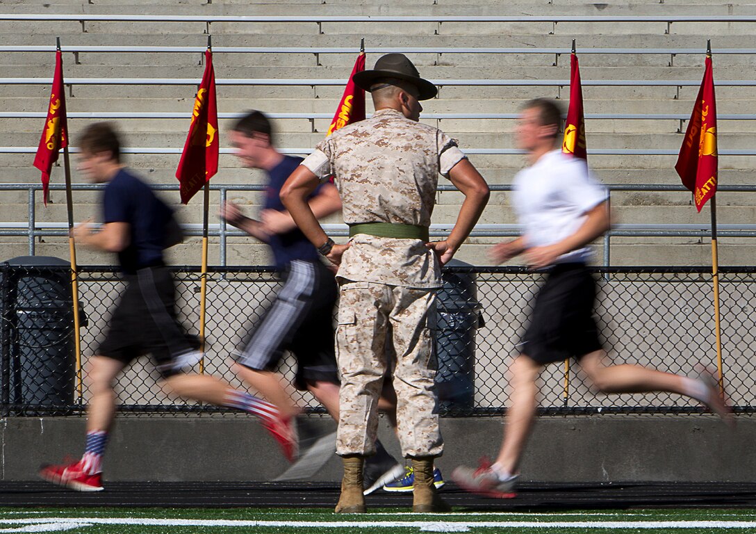 Sgt. Jonathon Lopez, a drill instructor with Charlie Company, 1st Recruit Training Battalion, Marine Corps Recruit Depot San Diego, observes poolees as they perform an initial strength test during Recruiting Station Seattle’s annual west side pool function at Foster High School in Tukwila, Wash., Sept. 13, 2014. During the event, Washington-based recruiters teamed with drill instructors to physically and mentally prepare enlistees for boot camp. The enlistees, part of the Marine Corps delayed entry program, are awaiting their ship dates. Lopez, 28, is from San Juan, Puerto Rico. (U.S. Marine Corps photo by Sgt. Reece Lodder)