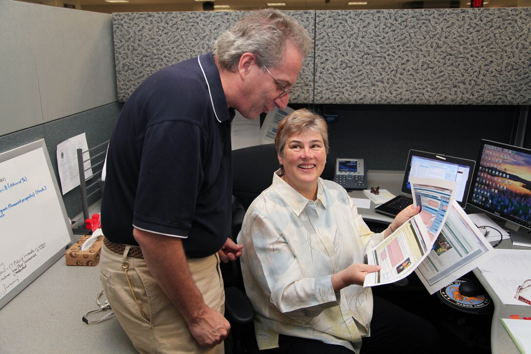 Ed Gauvreau, left, chief of the Installation Support Division, Planning Branch, discusses a project with Sheron Belcher, Huntsville Center's Engineering Directorate, during her four-month assignment at Headquarters, U.S. Army Corps of Engineers as part of the Senior Leadership Development Fellow program.  