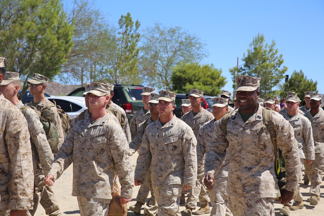 First Sgt. Frank Robinson, Weapons Company first sergeant, calls cadence as the Marines from Weapons Company, 1st Battalion, 7th Marine Regiment march towards their families at Del Valle Field Sept. 11, 2014. Marines from Headquarters and Support Company were also returning from Afghanistan on Sept. 11. 