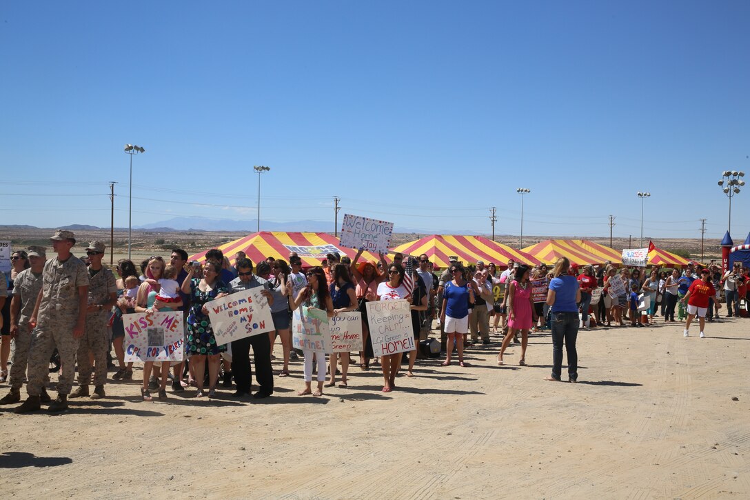 Combat Center families await the arrival of their Marines at Del Valle Field Sept. 11, 2014. The Marines and sailors of Headquarters and Support and Weapons Companies, 1st Battalion, 7th Marine Regiment were redeployed after six months in Afghanistan.  