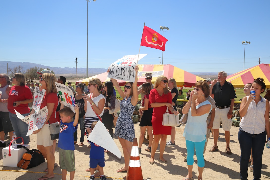 Combat Center families cheer as the Marines and sailors with 1st Battalion, 7th Marine Regiment march towards them at Del Valle Field Sept. 11, 2014. More than 200 Marines and sailors were reunited after six months in Afghanistan. They were from Headquarters and Support and Weapons Companies.