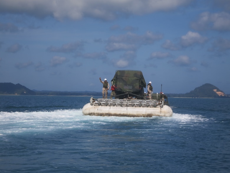 The LMCS, loaded with a Humvee, is towed to the beach near Mersing, Malaysia.