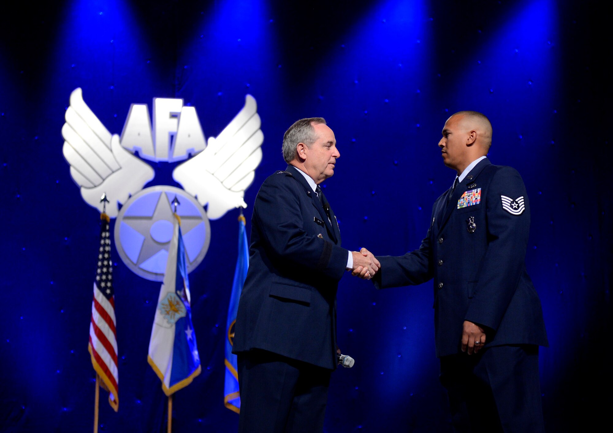 Air Force Chief of Staff Gen. Mark A. Welsh II congratulates Tech. Sgt. Brian Williams for winning the "American Airman" video contest during his keynote speech at the Air Force Association's Air & Space Conference and Technology Exposition Sept. 16, 2014, in Washington, D.C. Williams currently serves with the 87th Security Forces Squadron at Joint Base McGuire-Dix-Lakehurst, N.J., his video received 1,814 votes. (U.S. Air Force photo/Scott Ash)