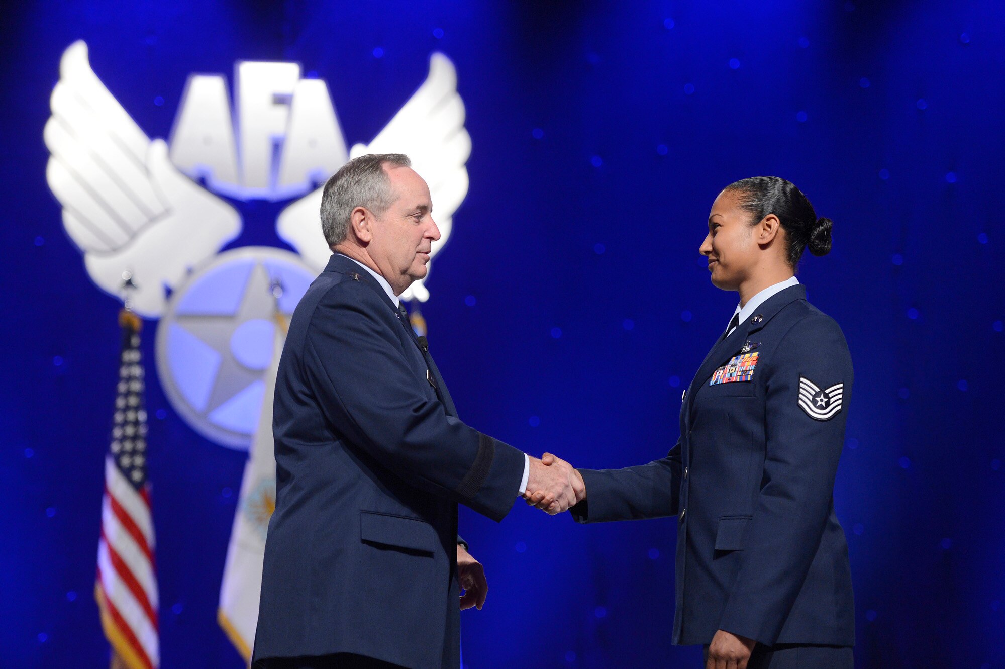 Air Force Chief of Staff Gen. Mark A. Welsh III congratulates Tech. Sgt. Shevaun Reighter during his keynote speech at the 2014 Air Force Association's Air and Space Symposium and Technology Exposition, Sept. 16, 2014 in Washington, D.C..  (U.S. Air Force photo/Scott M. Ash)