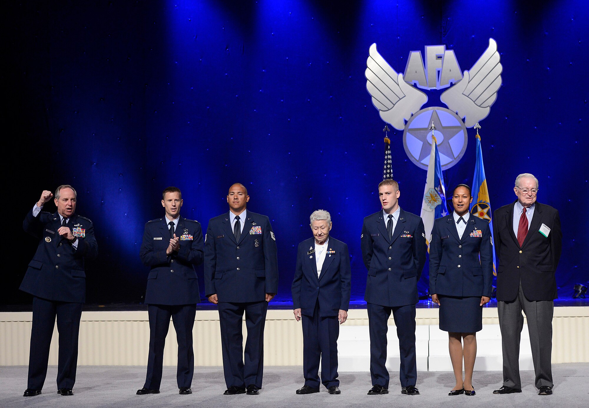 Air Force Chief of Staff Gen. Mark A. Welsh III sings the "Air Force" song with Tech. Sgt. Maj. Eric Reagan, Tech. Sgt. Bryan Williams, Col. Mary Felk, from the Civil Air Patrol, Tech. Sgt. Shevaun Reighter, and Air Force civic leader, Parker Green, following his keynote speech at the 2014 Air Force Association's Air and Space Symposium and Technology Exposition, Sept. 16, 2014, in Washington, D.C.  (U.S. Air Force photo/Scott M. Ash)