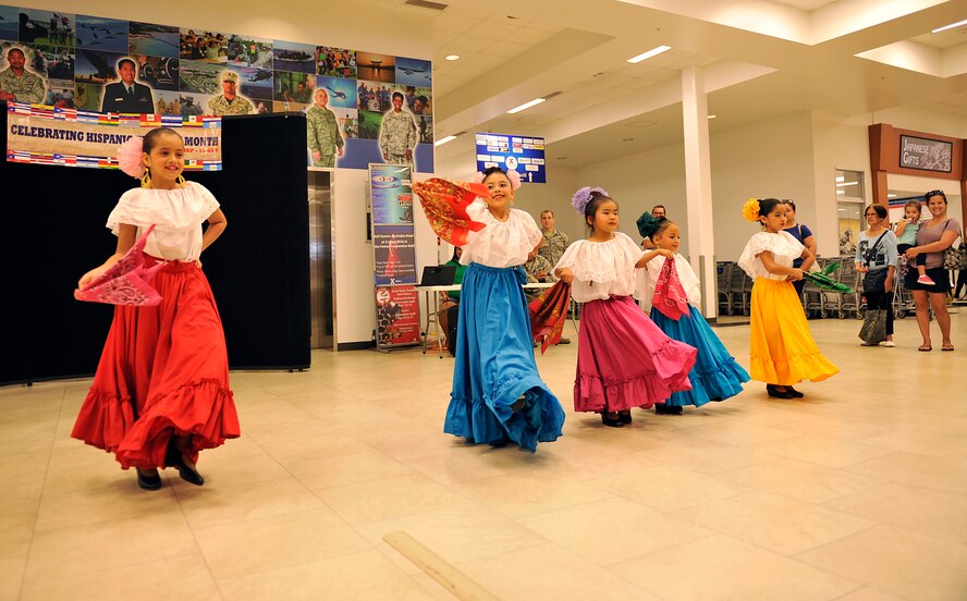 Children perform the "Mujeres De Sa Pina" during Hispanic Heritage Month at the base exchange on Kadena Air Base, Japan, Sept. 15, 2014. Approximately 30 dancers performed from three different dance groups: Folklorico Mexicano de Okinawa, Son de Cafe de Colombia and Ritmo, Color y Sabor de Peru. (U.S. Air Force photo by Naoto Anazawa/Released)