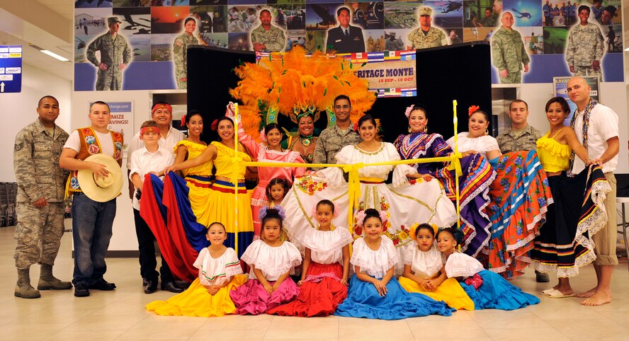 Members of the Hispanic Heritage Committee pose for a group photo before kicking off Hispanic Heritage Month at the base exchange on Kadena Air Base, Japan, Sept. 15, 2014. The event was held to kick off the heritage month festivities and included traditional Hispanic dance. Approximately 30 dancers performed from three different dance groups: Folklorico Mexicano de Okinawa, Son de Cafe de Colombia and Ritmo, Color y Sabor de Peru. (U.S. Air Force photo by Naoto Anazawa/Released)
