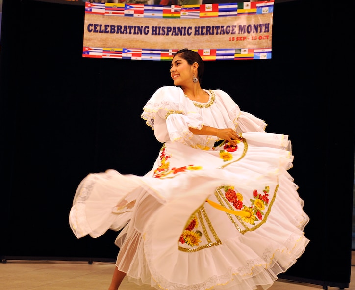 Laura Rodriguez, a dancer from Son de Cafe de Colombia, performs the "El San Juanero" during Hispanic Heritage Month at the base exchange on Kadena Air Base, Japan, Sept. 15, 2014. Hispanic Heritage Month is a time to celebrate and commemorate the contributions that Hispanics have made to American culture, history and the armed forces. (U.S. Air Force photo by Naoto Anazawa/Released)