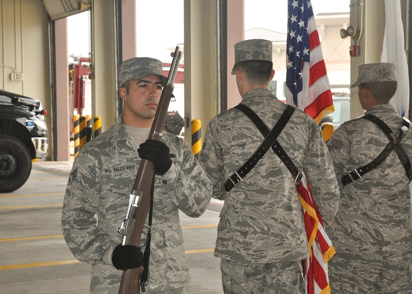 Senior Airman Kenneth Del Valle-Ruiz, 51st Maintenance Group plans, scheduling and documentation journeyman, guards the flags during a base honor guard presentation, at Osan Air Base, Republic of Korea, Sept. 8, 2014. Leadership from across Team Osan participated in the annual Mustang Immersion to develop a better understanding of what Osan Airmen are able to bring to the fight. (U.S. Air Force photo by Capt. Robert Howard/Released) 