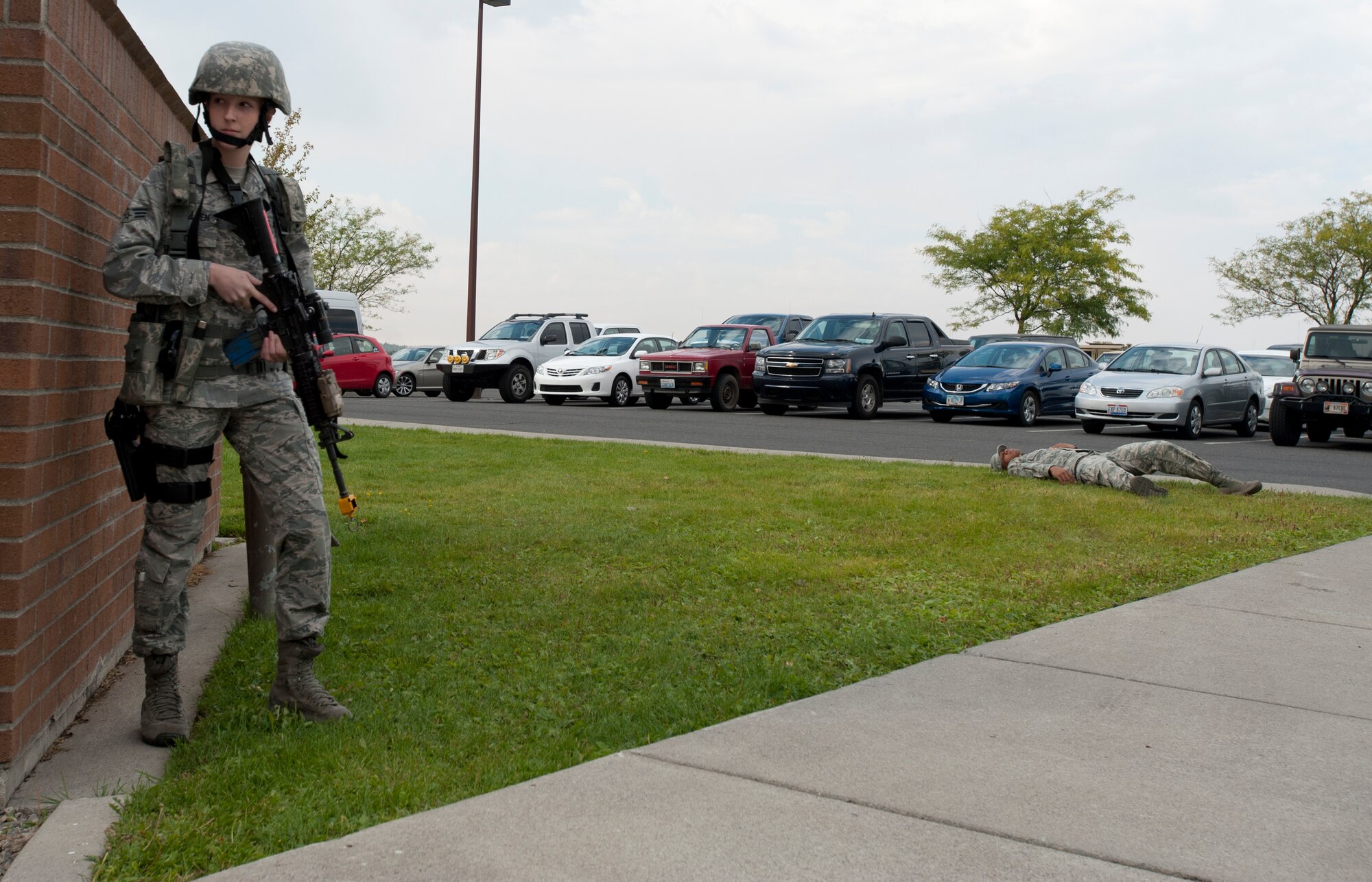 A 92nd Security Forces Squadron Airman takes cover during an active shooter exercise at the Survival, Evasion, Resistance and Escape dorms at Fairchild Air Force Base, Washington, Sept. 16, 2014. The exercise was to prepare the Airman for real life situations where an active shooter could pose a threat.  (U.S. Air Force photo by Airman 1st Class Taylor Bourgeous/Released)