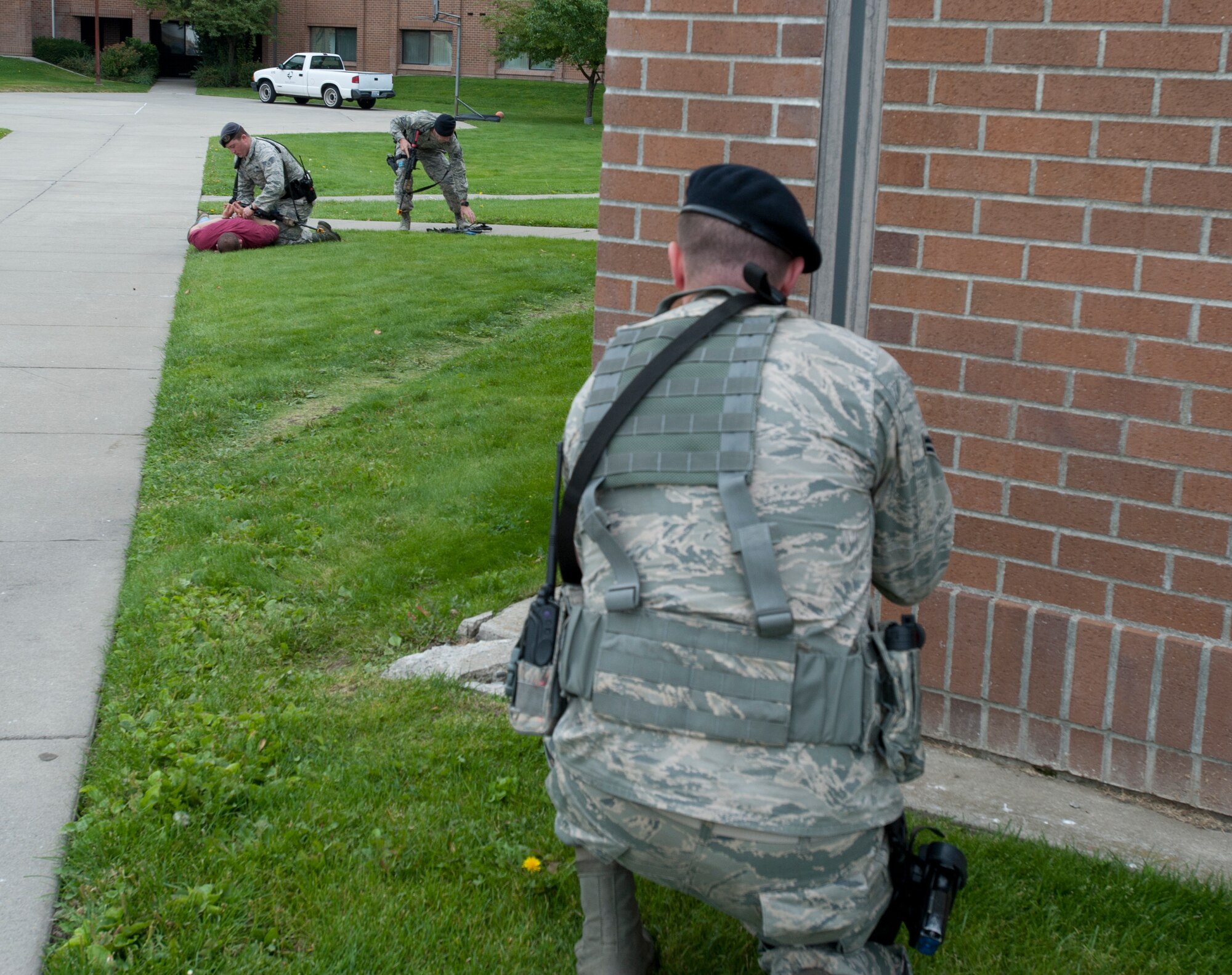 Airmen from the 92nd Security Forces Squadron participate in an active shooter exercise at Fairchild Air Force Base, Washington, Sept. 16, 2014. The exercise was to help educate the students at the Survival, Evasion, Resistance and Escape school of what to do if an active shooter was present. (U.S. Air Force photo by Airman 1st Class Taylor Bourgeous/Released)