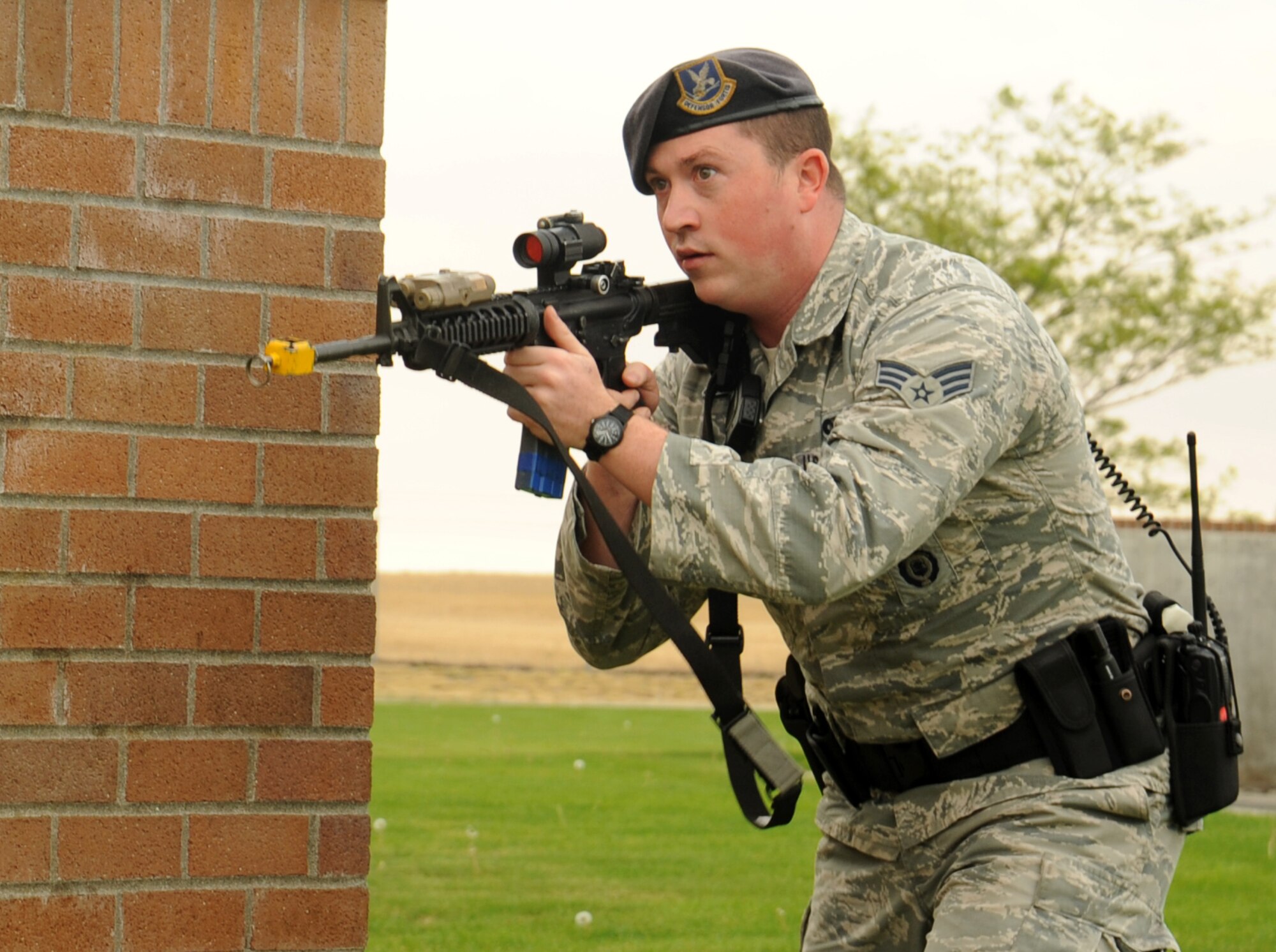 Senior Airman Dustin Kimball, 92nd Security Forces Squadron patrolman, secures a building at the Survival Evasion Resistance and Escape dorms during a scenario in active shooter training at Fairchild Air Force Base, Washington, Sept. 16, 2014. The training is designed to prepare 92nd SFS personnel to respond to a shooting incident in a school or work center. (U.S. Air Force photo by Staff Sgt. Samantha Krolikowski/Released)