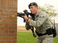 Senior Airman Dustin Kimball, 92nd Security Forces Squadron patrolman, secures a building at the Survival Evasion Resistance and Escape dorms during a scenario in active shooter training at Fairchild Air Force Base, Washington, Sept. 16, 2014. The training is designed to prepare 92nd SFS personnel to respond to a shooting incident in a school or work center. (U.S. Air Force photo by Staff Sgt. Samantha Krolikowski/Released)