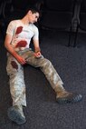 Airman 1st Class Phillip Gandhi, technical school student, role plays during an active shooter exercise in the Survival Evasion Resistance and Escape dorms at Fairchild Air Force Base, Washington, Sept. 16, 2014. The training occurred to prepare students on what to do if an actual active shooter situation takes place. (U.S. Air Force photo by Staff Sgt. Samantha Krolikowski/Released)