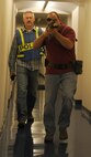 Tech Sgt. Derek Washburn, 92nd Security Forces flight sergeant, and J. Colt, 92nd SFS trainer, participates in an active shooter exercise at Fairchild Air Force Base, Washington, Sept. 16, 2014. The exercise occurred in the Survival Evasion Resistance and Escape dorms to help prepare students for what to do in the event a shooting takes place within the confines of the base. (U.S. Air Force photo by Staff Sgt. Samantha Krolikowski/Released)