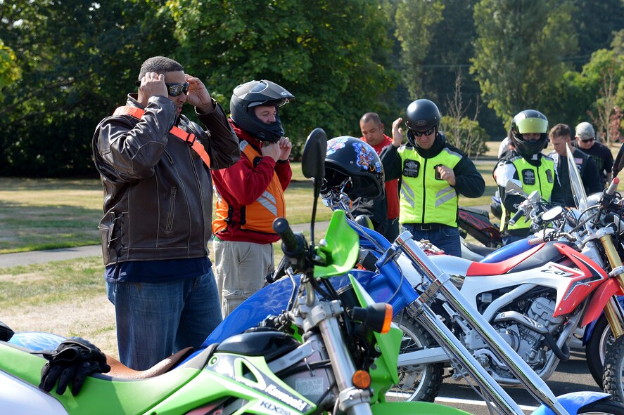 Bike riders put their equipment on Sept. 16, 2014 during the POW/MIA motorcycle ride at Joint Base Lewis-McChord, Wash. The group went on a ride to Orting, Wash., where they had a cookout with members of the Washington State Soldiers Home. (U.S. Air Force photo/Airman 1st Class Keoni Chavarria)