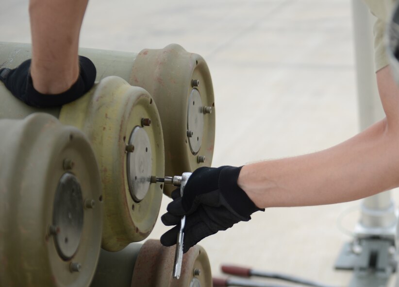 U.S. Air Force Airman 1st Class Jack Deaton, 7th Munitions Squadron conventional maintenance crewmember, moves shipping caps on inert bomb components during the Global Strike Challenge Sept. 11, 2014, at Dyess Air Force Base, Texas. This year, Dyess participated in the bomber operations and bomber maintenance categories of the competition. (U.S. Air Force photo by Airman 1st Class Kedesha Pennant/Released)