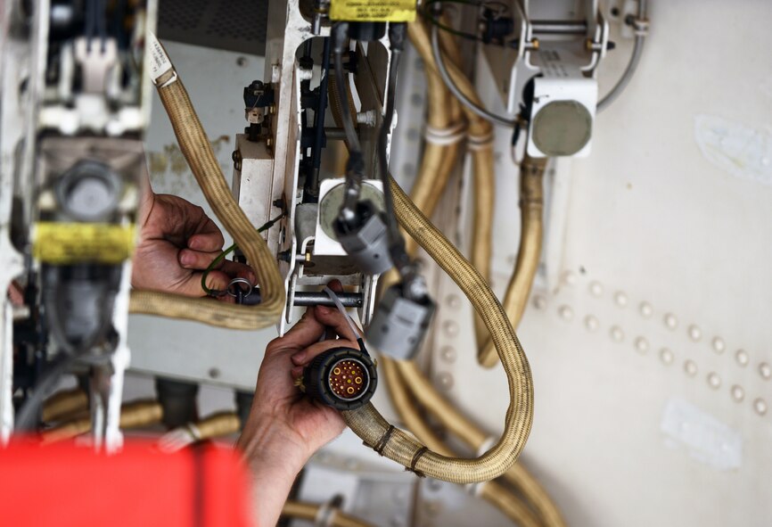 U.S. Air Force Senior Airman Christopher Sanders, 7th Aircraft Maintenance Squadron weapons load crewmember, inspects bomb cables on a B-1B Lancer during the Global Strike Challenge Sept. 11, 2014, at Dyess Air Force Base, Texas. Dyess, along with Ellsworth Air Force Base, S.D., represented Air Combat Command in this year’s competition. (U.S. Air Force photo by Airman 1st Class Kedesha Pennant/Released)