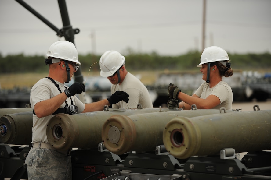 Airmen from the 7th Munitions Squadron insert fuses into inert bomb bodies as part of the munitions assembly portion of the Global Strike Challenge Sept. 11, 2014, at Dyess Air Force Base, Texas. The standard time of assembly is an hour and twenty-five minutes. Team Dyess was able to complete this portion of the competition in an hour and fifteen minutes. Overall results from the competition will be released Nov. 4-5. (U.S. Air Force photo by 2nd Lt. Lauren Linscott/Released)