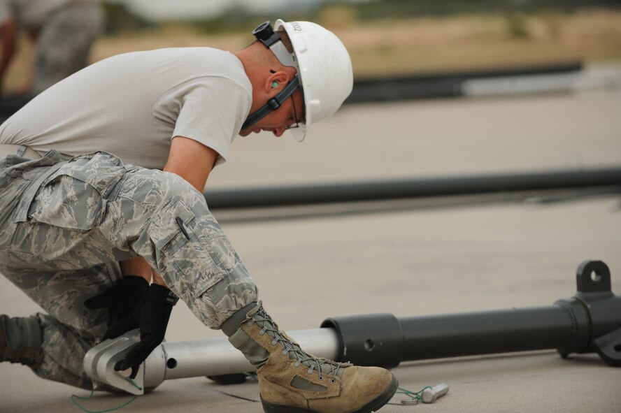 U.S. Air Force Senior Airman Richard A. Gerber II, 7th Munitions Squadron munitions operations technician, extends a gantry leg on a munitions assembly conveyor during the Global Strike Challenge Sept. 11, 2014, at Dyess Air Force Base, Texas. In 2012, the 7th Operations Support Squadron at Dyess earned the titles of best bomb squadron and best B-1B squadron for their performance in the Global Strike Challenge. (U.S. Air Force photo by 2nd Lt. Lauren Linscott/Released)

