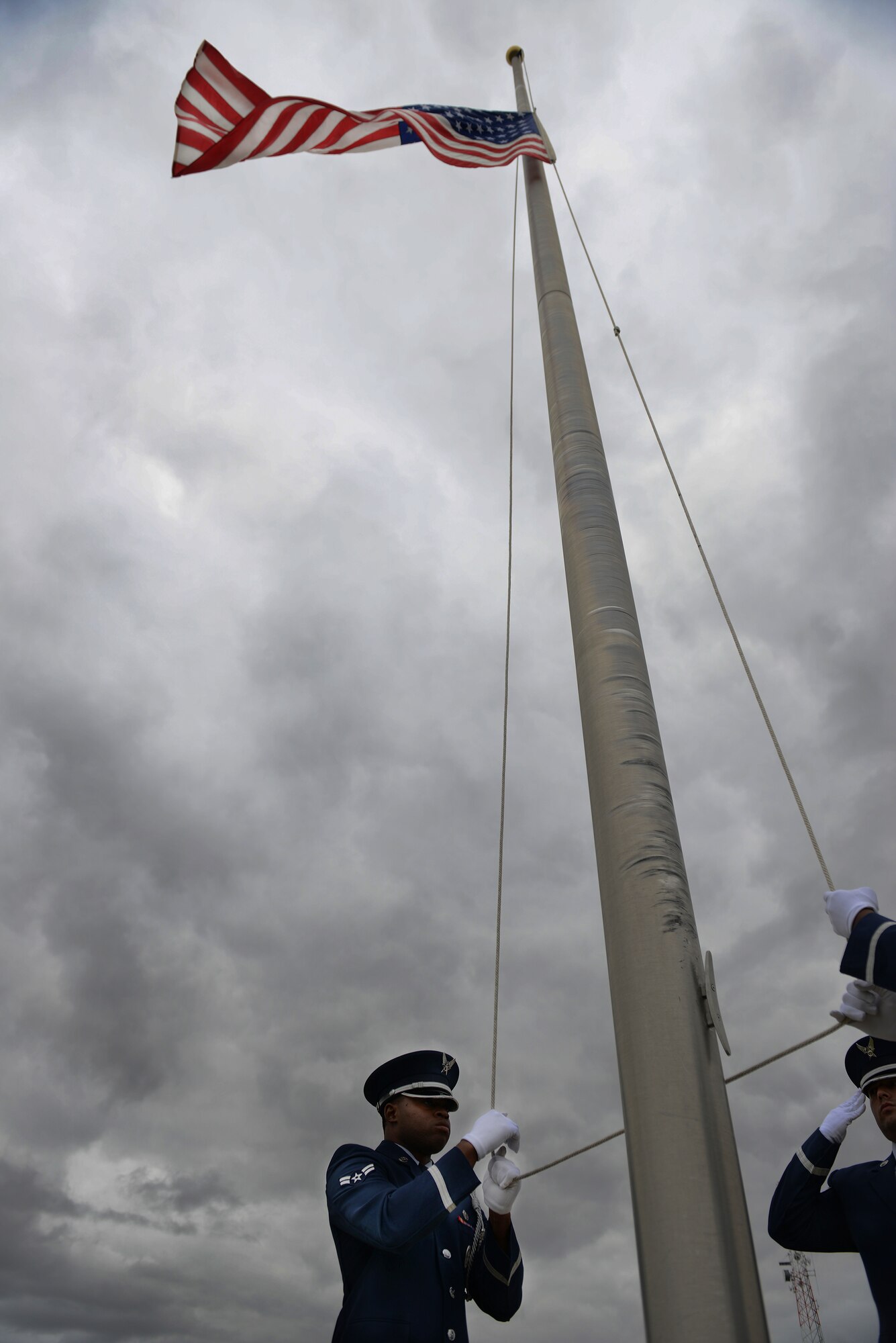 The flag is lowered by the Minot Air Force Base Honor Guard during a Sept. 11 memorial ceremony on Minot AFB, N.D. The ceremony allowed Airmen and their families to remember those who lost their lives  in the 2001 attacks. (U.S. Air Force photos/Airman 1st Class Lauren Pitts) 