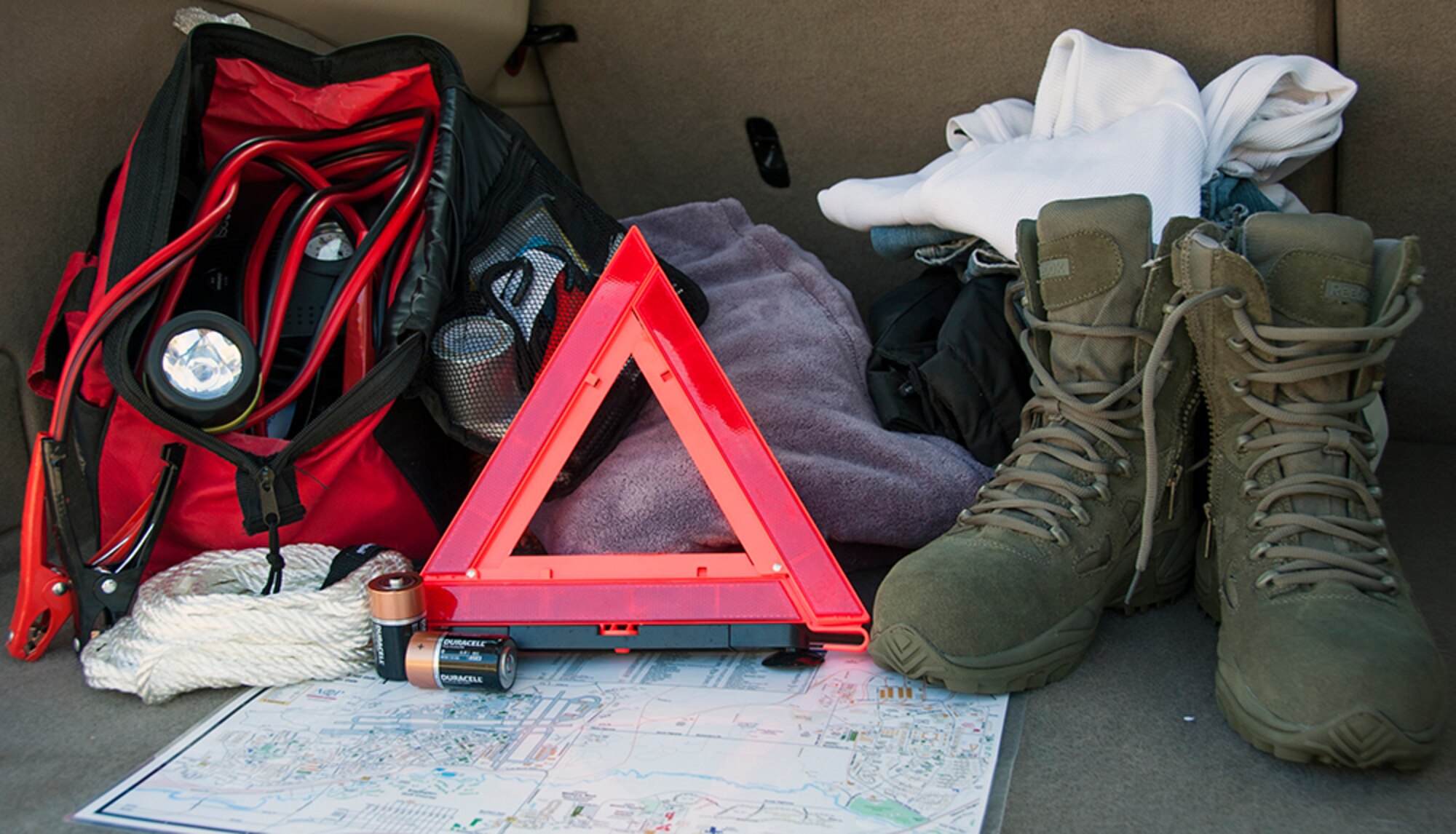 Roadside kits, like the one pictured above, should contain jumper cables, a flashlight, first aid kit, fluorescent distress signal and battery charger. Emergency preparedness kits should be included in everyday travel at any time of the year. During the winter months, kits should include an extra set of warm clothing, winter boots, socks, cold weather jacket and coveralls, water, snacks, and sand. (U.S. Air Force photo/Airman 1st Class Tammie Ramsouer) 
