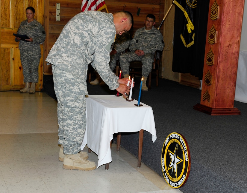 U.S. Army 1st. Sgt. Franklin Davila, Army Forces Battalion first sergeant, lit the three candles which signify different ideals a NCO encompasses as Joint Task Force-Bravo welcomed the newest members of the Non-Commissioned Officer Corps for the U. S. Army and Air Force in their first-ever joint NCO induction ceremony September 5, 2014.  Twenty-five NCOs from the Army Forces Battalion and Medical Element took part in the time-honored tradition symbolizing their change from a follower to a leader for current and future service members.  (Photo by Martin Chahin)
