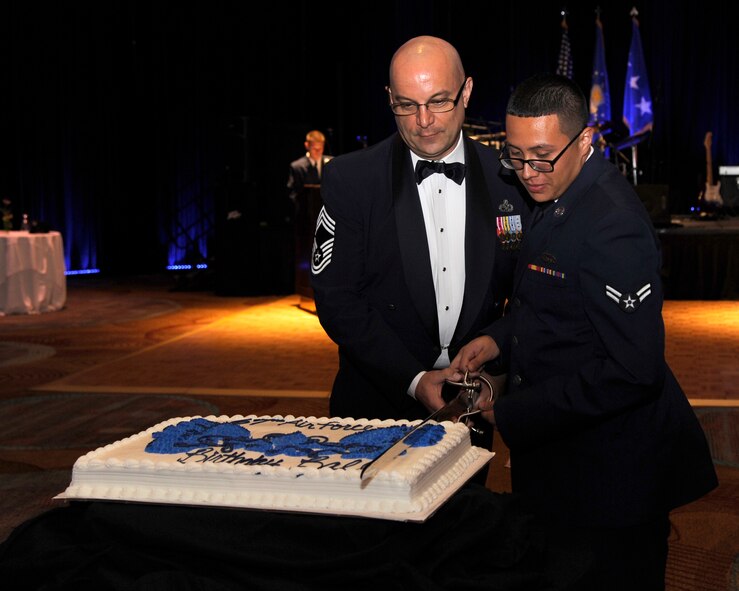 Chief Master Sgt. Gary Hunkins, 2nd Mission Support Group superintendent, and Airman 1st Class Llunas Gonzalez, 2nd Maintenance Squadron, cut the cake during the Air Force Birthday Ball at Sam's Town Hotel and Casino, Shreveport, La., Sept. 13, 2014. Hunkins and Llunas were chosen to cut the cake because they were the most senior and junior enlisted members in attendance. (U.S. Air Force photo/Senior Airman Joseph A. Pagán Jr.)