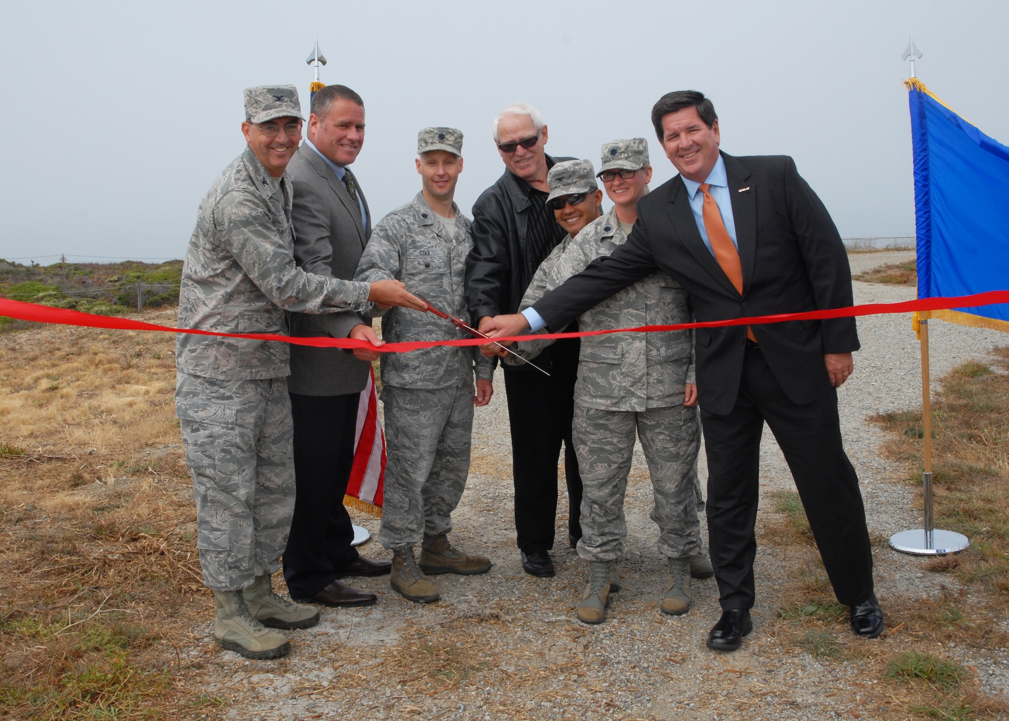 Col. Keith Balts, 30th Space Wing commander, Richard Schoonmaker, InDyne contract manager, Lt. Col. Timothy Cole, Space and Missile Systems Range and Network Division deputy chief, Helmut Erhard, Pillar Point Air Force Station supervisor, Col. Marcelino Del Rosario, 30th Operations Group commander, Lt. Col. Jennifer Berenger, 30th Range Management Squadron commander, and Tom Bouthiller, Spacelift Range System Contract Program Director, participate in a ribbon cutting ceremony, Sept. 10, 2014, at Pillar Point Air Force Station, Calif.  The ceremony marked the modernization of Pillar Point through the installment of the new Command Transmitter 4. (U.S. Air Force photo by Senior Airman Armando Aparicio Jr./Released)
