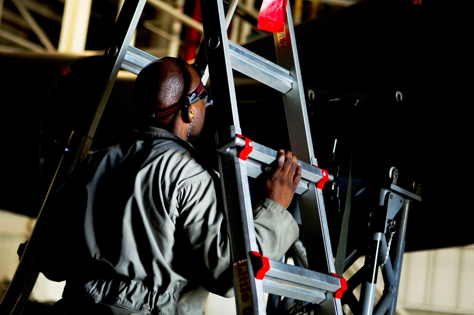 Staff Sgt. Kelvin McCrea, 5th Aircraft Maintenance Squadron weapons load crew member, carries a ladder to a B-52H Stratofortress during a weapons load on Minot Air Force Base, N.D., Sept. 5, 2014. McCrea is a part of the weapons load crew competing in the 2014 Global Strike Challenge. (U.S. Air Force photo/Senior Airman Brittany Y. Bateman)