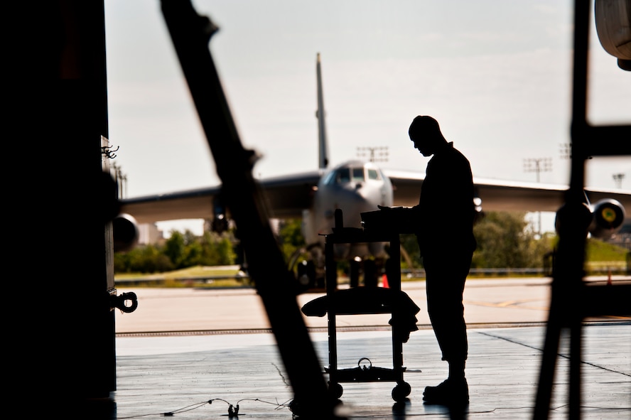 Master Sgt. Iickyra Jones, 5th Aircraft Maintenance Squadron load standardization crew chief, looks at a binder on Minot Air Force Base, N.D., Sept. 5, 2014 during a weapons load. The load crew is evaluated on how quickly they load munitions on a B-52H Stratofortress and how many discrepancies are found. (U.S. Air Force photo/Senior Airman Brittany Y. Bateman)