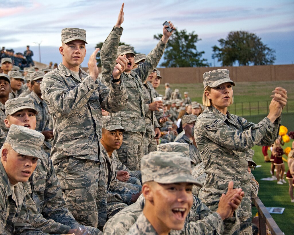 U.S. Air Force Airmen, 82nd Training Group, cheer on the Midwestern State University Mustangs at a football game with the Missouri S&T at the Memorial Stadium, on September 13, 2014, Wichita Falls, Texas. Military members receive free admission to the game. (U.S. Air Force photo by Frank Carter/Released)