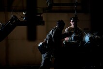 Staff Sgt. Kelvin McCrea and Senior Airman Andrew Grimes, 5th Aircraft Maintenance Squadron weapons load crew members, load a joint direct attack GBU-38 munition from a trailer onto a MJ-1 Jammer on Minot Air Force Base, N.D., Sept. 5, 2014. The load crew is evaluated on how quickly they load munitions on a B-52H Stratofortress and how many discrepancies are found. (U.S. Air Force photo/Senior Airman Brittany Y. Bateman)
