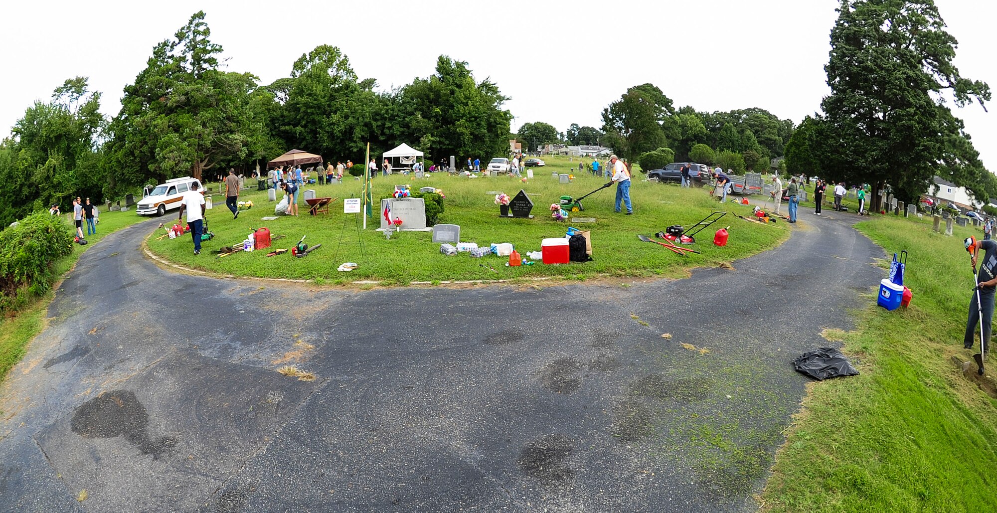 Volunteers help clean up the Oakland Cemetery in Hampton, Va., Sept. 13, 2014. More than 200 veterans trimmed grass, pruned trees and discarded unwanted materials to help improve the appearance of the cemetery where many U.S. Service members are buried. (U.S. Air Force photo by Airman 1st Class Areca T. Wilson/Released) 